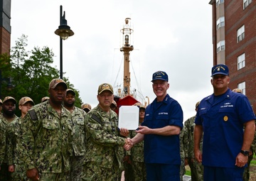 Coast Guard Vice Adm. Kevin Lunday, Atlantic Area Commander, presents the crew of the USS Hershel "Woody" Williams with the Coast Guard Special Operations Service Ribbon