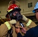 Sailor dons fire-fighting gear for a damage control drill aboard USS Carl Vinson