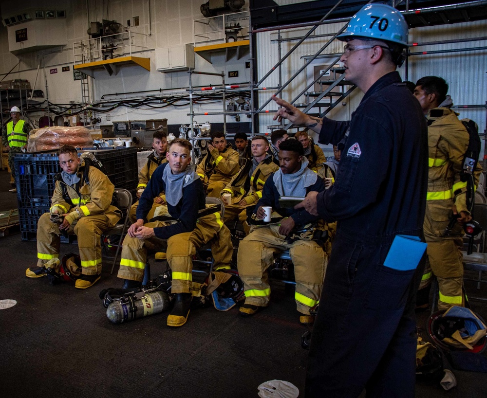 Sailors recieve instruction at staging area aboard USS Carl Vinson