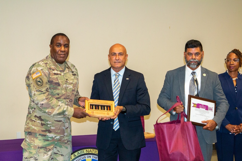 VING State Family Program presents community purple award to La Reine Chicken Shack