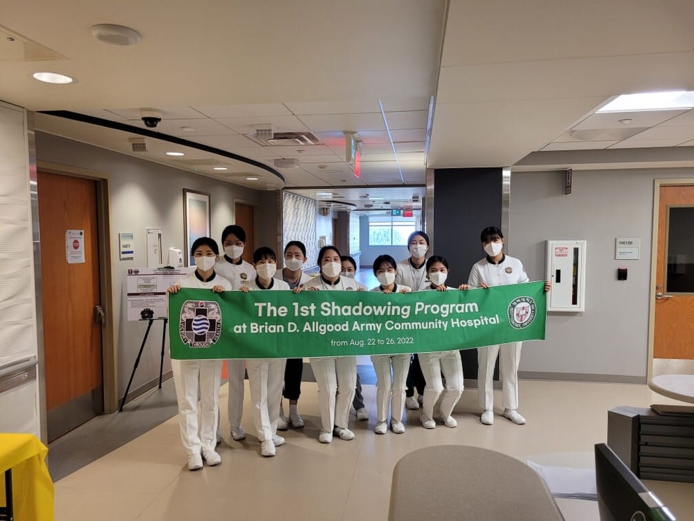 Pyeongtaek University Nurses pose with the banner for the 1st BDAACH-PTU Nursing Shadowing Program on Camp Humphreys