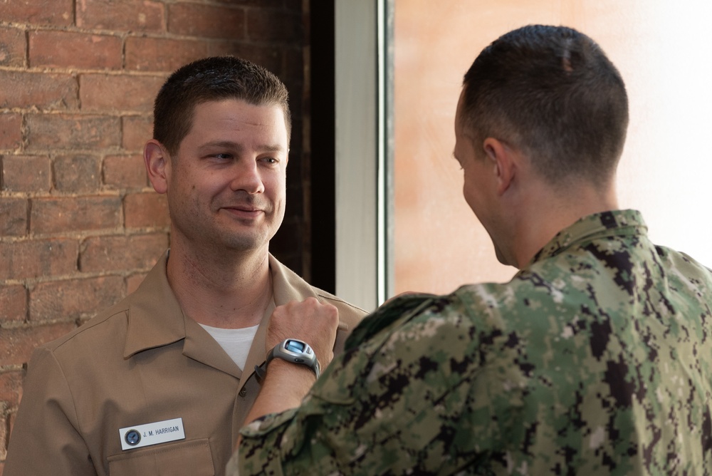 Musician 1st Class Jeff Harrigan is pinned upon arrival at U.S. Navy Band