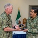 Rear Adm. Arturo García Fernández, Mexican Navy, chief of logistics section of the general staff of the Navy, and Rear Adm. Matthew Ott, U.S. Fleet Forces Command (USFFC), fleet supply officer, hold a gift exchange in the USFFC headquarters building.