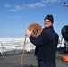 Coast Guard Cutter Healy crewmember stowing firehose