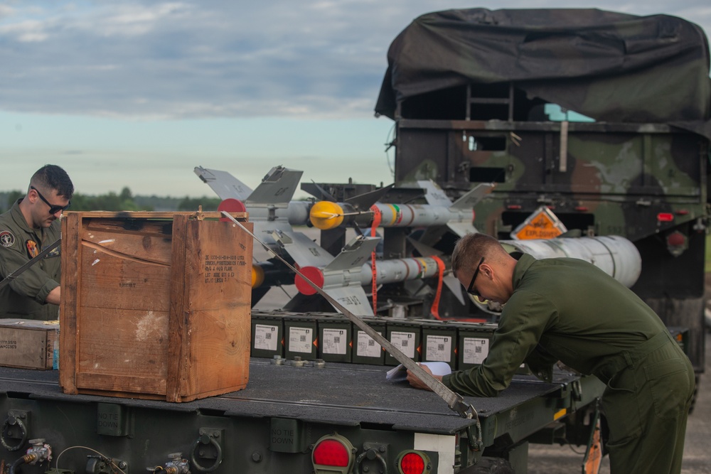 New Tricks For An Old Dog: Marines with VMA-223 load Air-to-Air missiles onto Harriers