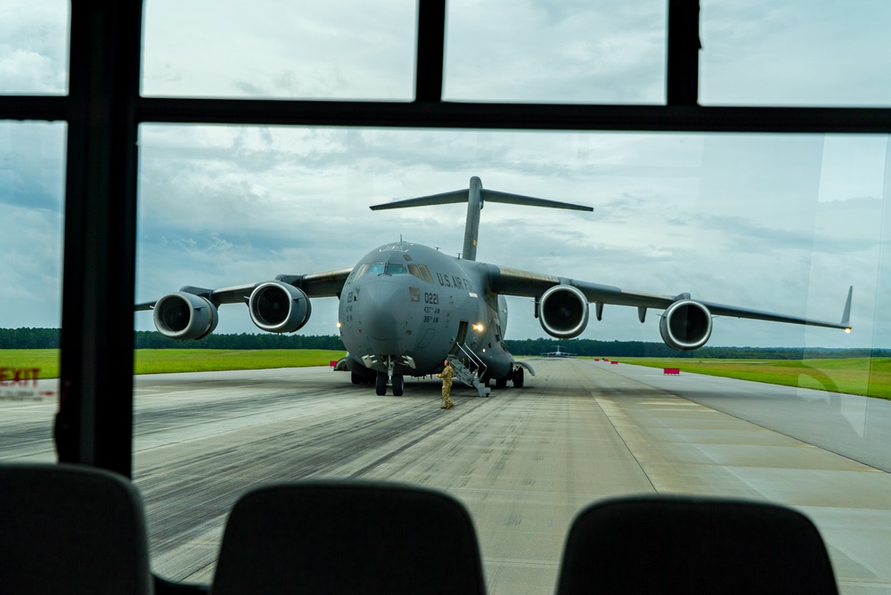 Local mayor visits AMC training field, catches a ride on C-17