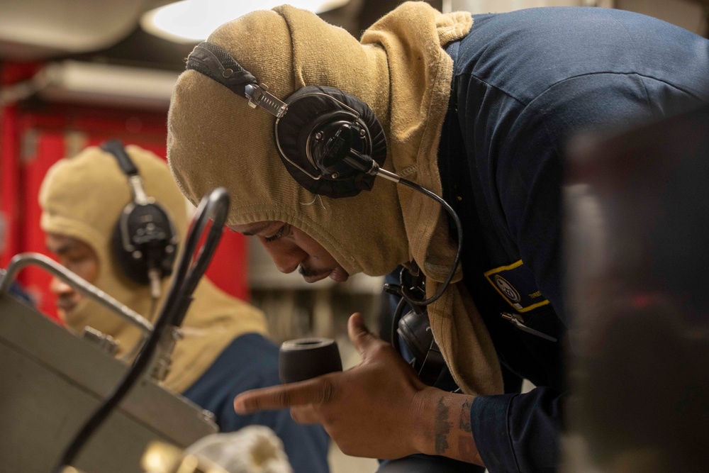 U.S. Navy Sailor Speaks into a Sound-Powered Telephone