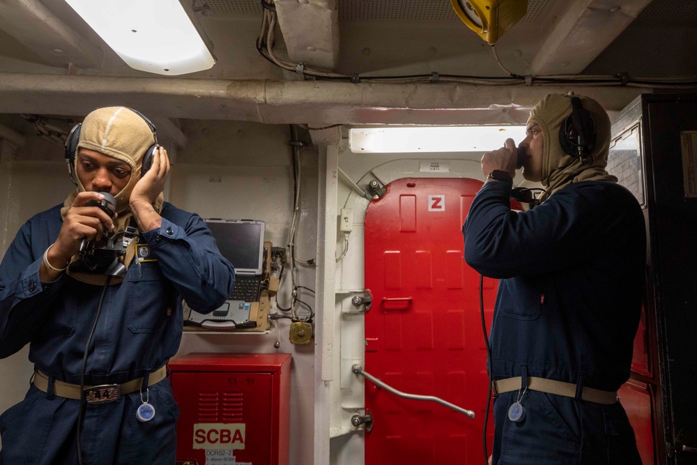 U.S. Navy Sailors talk on Sound-Powered Telephones