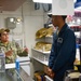 Petty Officer Third Class Leslie Benavides discusses the ship store evaluation with RSSN Eyric Williams during the full management review on aboard the USS Germantown on Aug 31. 2022.