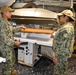 The Fleet Assistance Team inspects the laundry press to ensure it is in proper working condition during the full management review on aboard the USS Germantown on Aug 31. 2022.