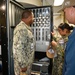 Petty Officer Third Class Leslie Benavides inspect the ships vending machine during the full management review on aboard the USS Germantown on Aug 31. 2022.