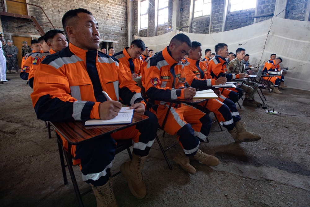 A Mongolia National Emergency Management Agency attends a class on shoring during exercise Gobi Wolf 2022