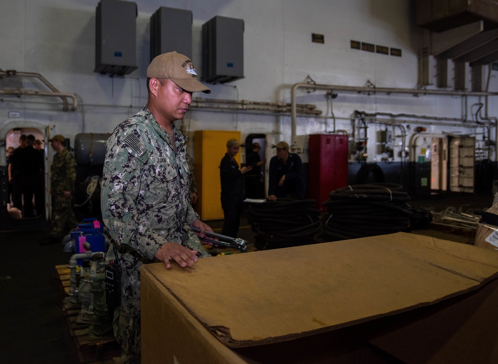 USS Ronald Reagan (CVN 76) Sailors prepare equipment for transfer