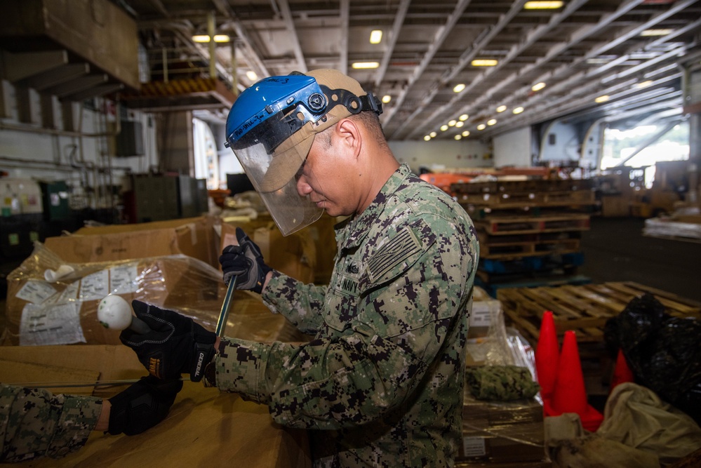USS Ronald Reagan (CVN 76) Sailors prepare equipment for transfer