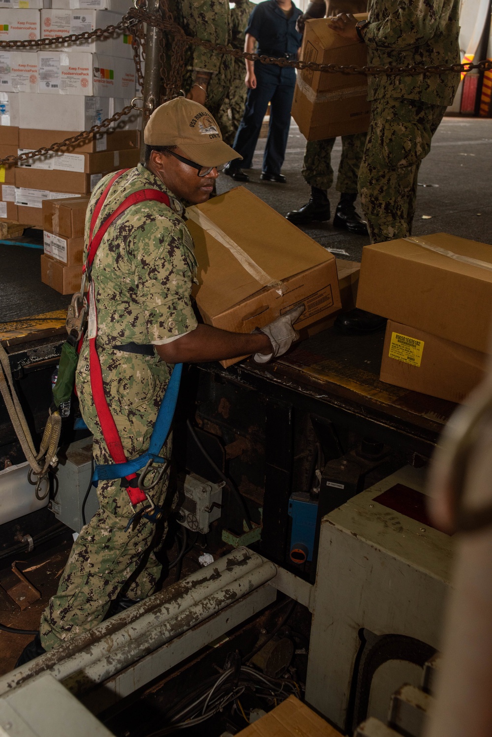 USS Ronald Reagan (CVN 76) Sailors on load cargo in hangar bay