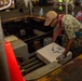 USS Ronald Reagan (CVN 76) Sailors on load cargo in hangar bay