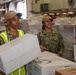 USS Ronald Reagan (CVN 76) Sailors on load cargo in hangar bay