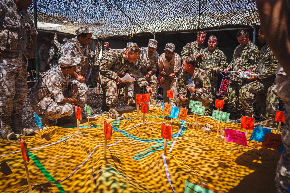 Jordanian and U.S. soldiers conduct terrain analysis on a sand table during the opening day of Exercise Eager Lion in Jordan, Sept. 4, 2022