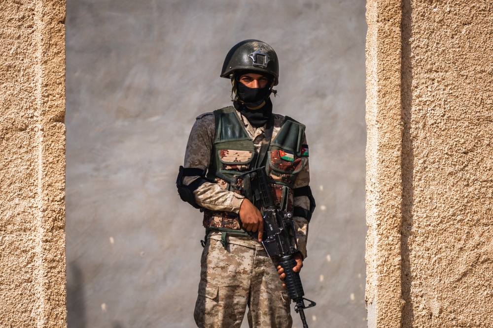 A soldier of the Jordanian Armed Forces pulls security