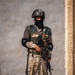 A soldier of the Jordanian Armed Forces pulls security