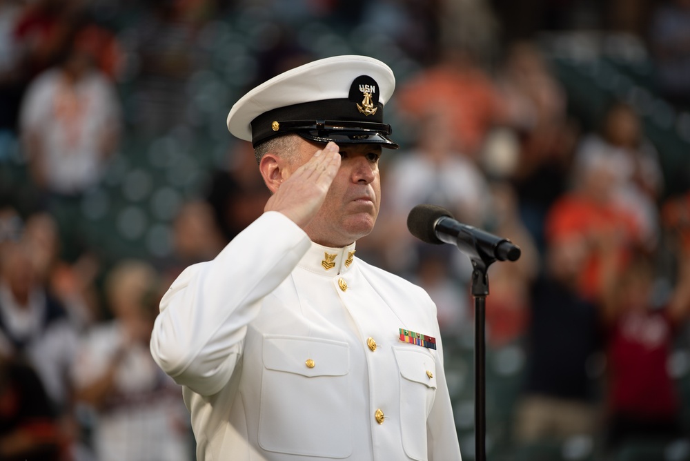 Musician 1st Class Robert A. Kurth sings the National Anthem at Orioles Park to celebrate Maryland Fleet Week