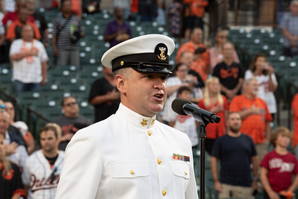 Musician 1st Class Robert A. Kurth sings the National Anthem at Orioles Park to celebrate Maryland Fleet Week