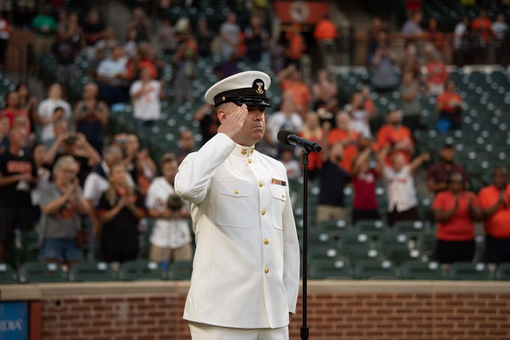 Musician 1st Class Robert A. Kurth sings the National Anthem at Orioles Park to celebrate Maryland Fleet Week
