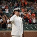 Musician 1st Class Robert A. Kurth sings the National Anthem at Orioles Park to celebrate Maryland Fleet Week