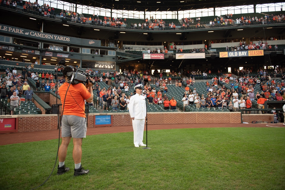 Musician 1st Class Robert A. Kurth sings the National Anthem at Orioles Park to celebrate Maryland Fleet Week