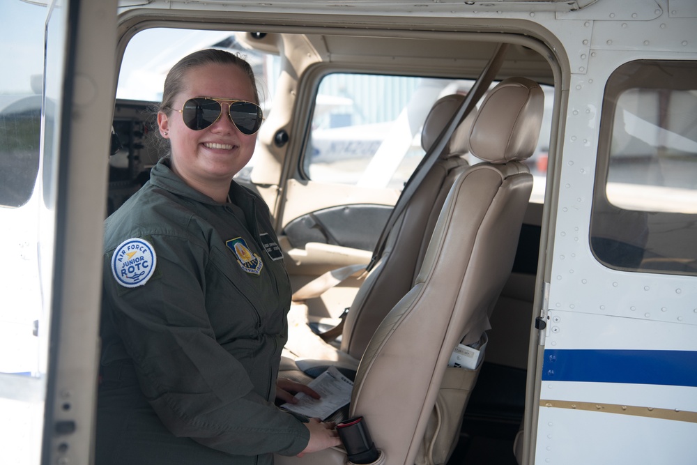 Cadet poses for photo in plane