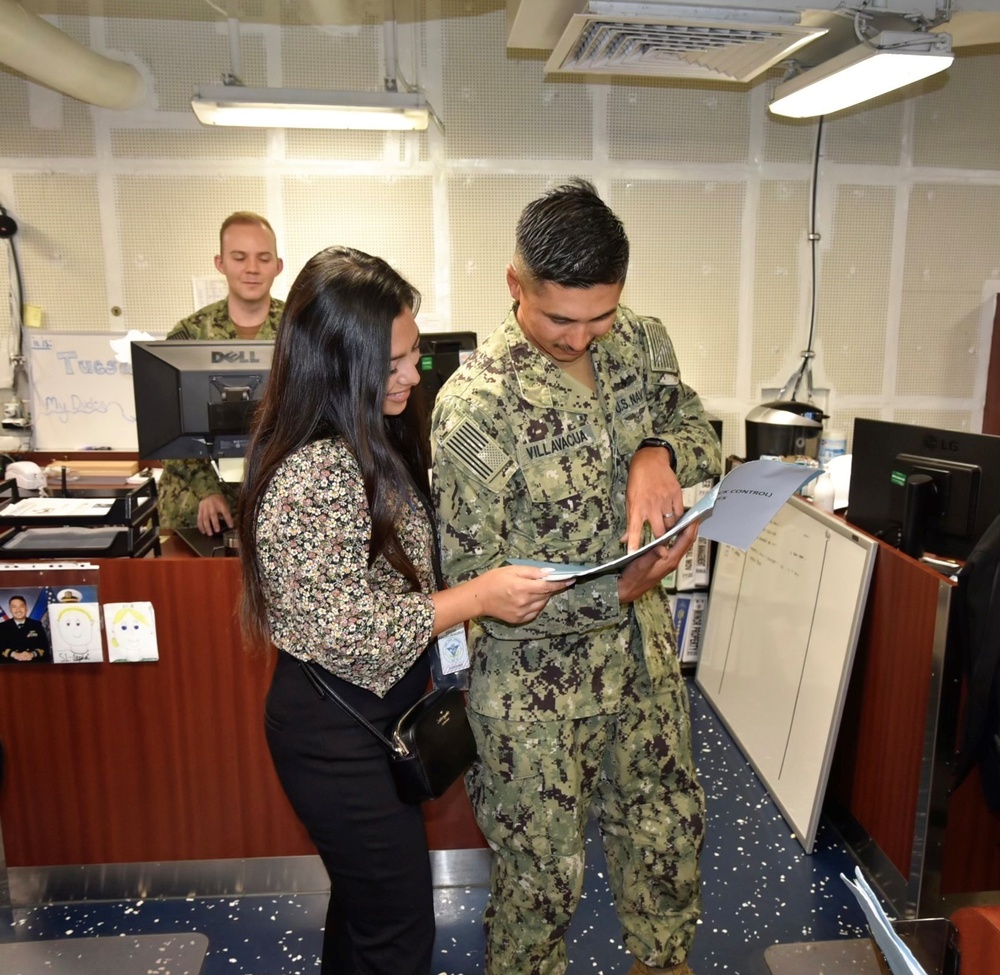 Global Distance Support Center customer service representative Denise Crave consults with Petty Officer First Class Chris Villavacua on stock control items aboard the USS Carl Vinson (CVN 70) in Coronado Ca. Sept. 14.