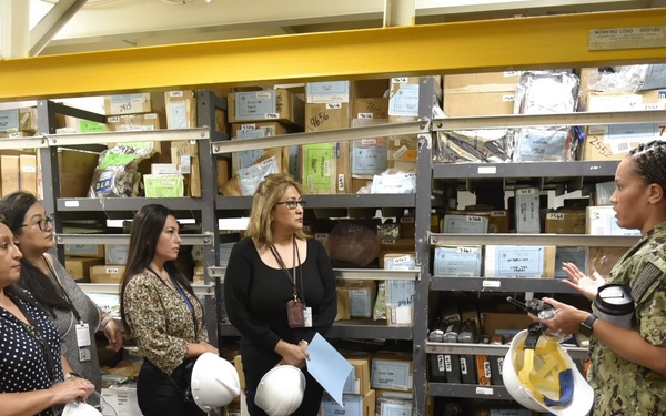 Lt. Jg. Lavetta Ryles gives tour of the USS Carl Vinson stock rooms to NAVSUP FLC San Diego GDSC employees on Sept. 14.