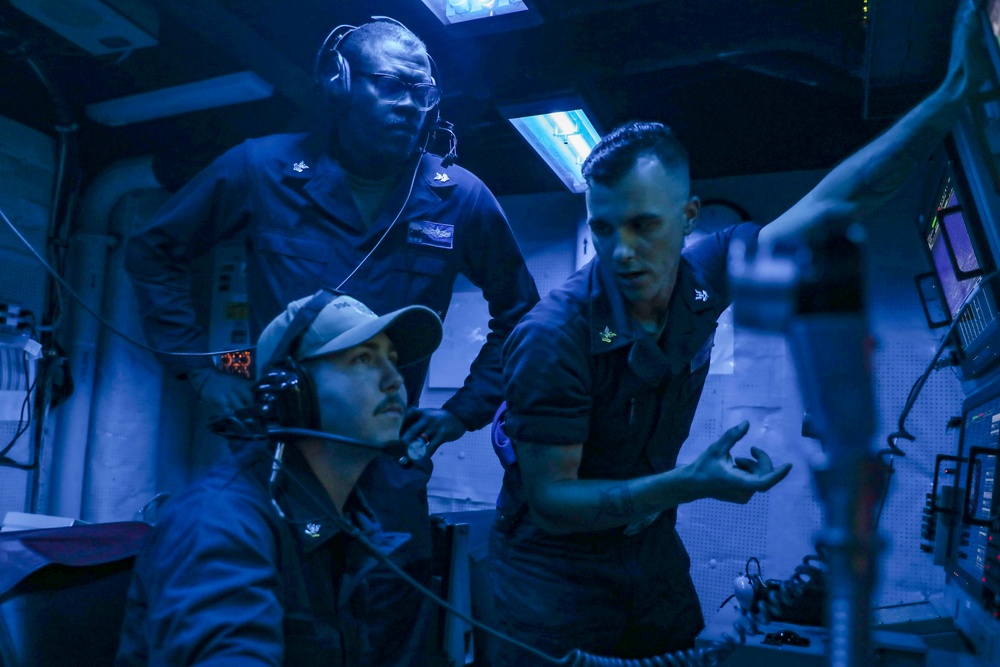 Sailors Stand Watch In Sonar Control Room On Board USS Higgins