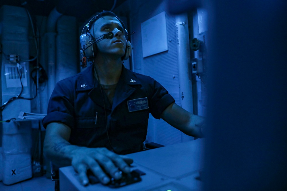 Sailors Stand Watch In Sonar Control Room On Board USS Higgins