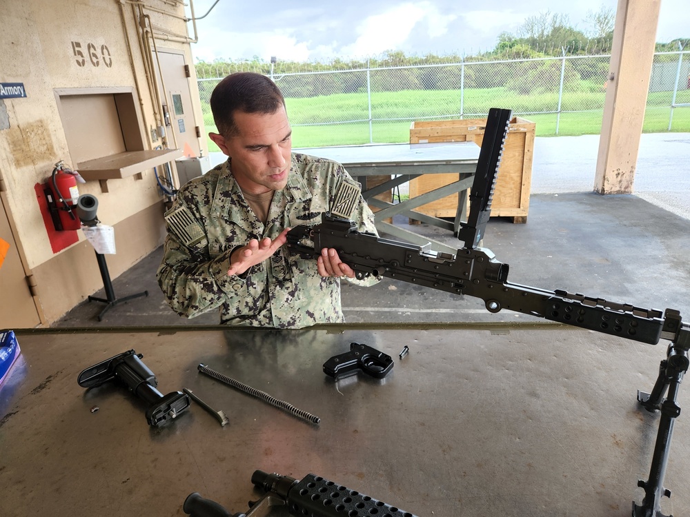 Seabees disassemble and reassemble weapons