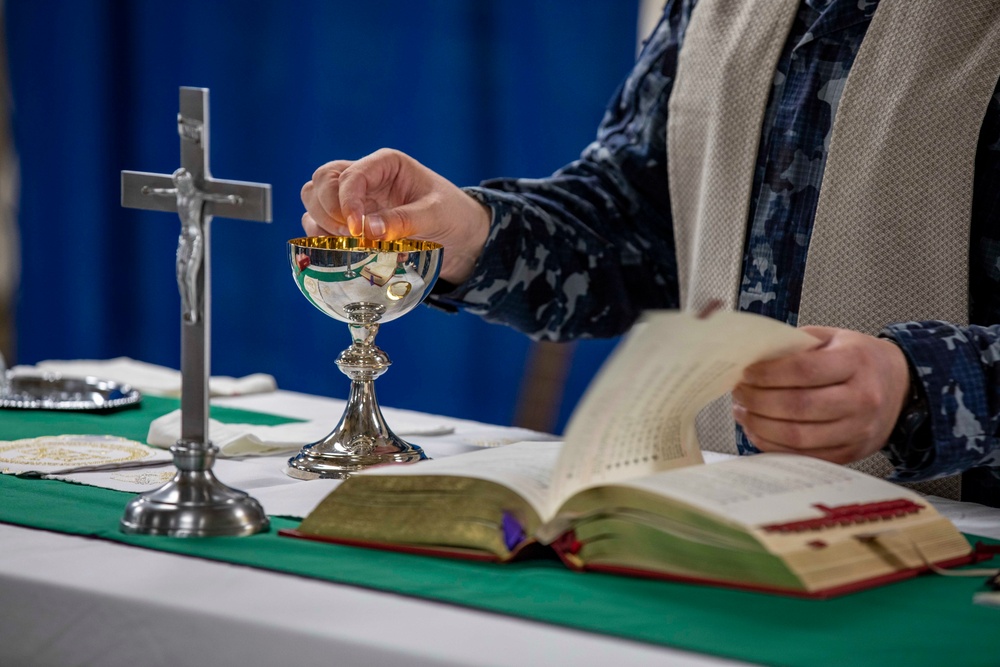 Lithuanian Navy chaplain conducts religious service aboard USS Arlington