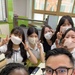 Naval Mobile Construction Battalion (NMCB) 4, pose for a selfie with local Chinhae all girls school and community center.