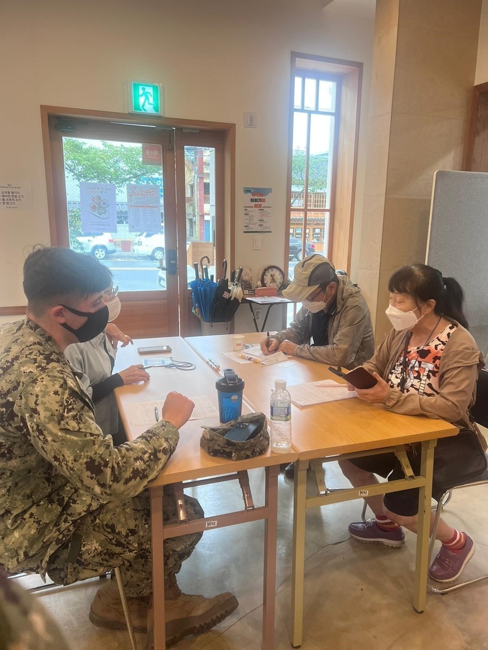 Naval Mobile Construction Battalion 4, volunteer their time to teach basic English lessons during a cultural exchange event with local students.