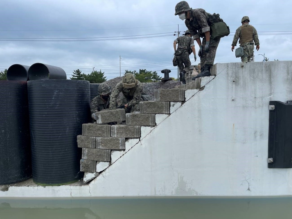 Naval Mobile Construction Battalion 4, repair pier damage during exercise Ulchi freedom Sheild.