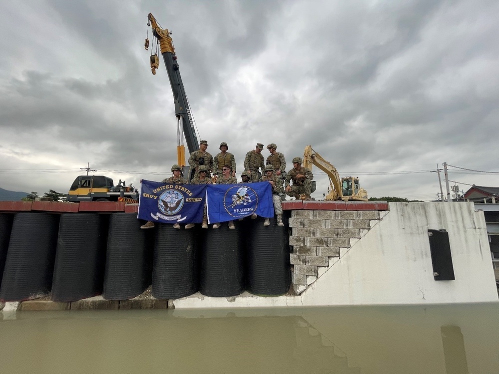 Naval Mobile Construction Battalion 4, pose for a group picture after completing a pier damage repair exercise Ulchi Freedom Shield.