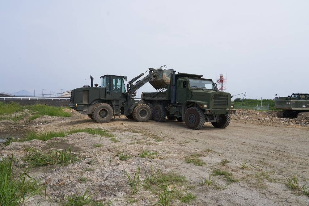 Naval Mobile Construction Battalion 4 and Marines conduct waste relocation.