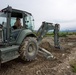 Naval Mobile Construction Battalion 4 remove overgrown vegetation and debris.