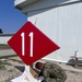 Seabees paint sign for NMCB-11 in Romania