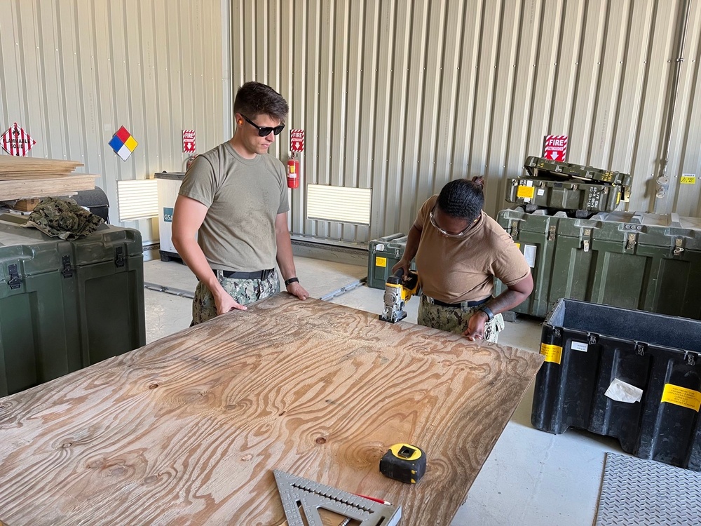 Seabees from NMCB-11 prepare to build benches for US Army