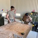 Seabees from NMCB-11 prepare to build benches for US Army