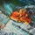 This is a dramatic oil painting depicting a maritime search and rescue operation viewed from an aerial perspective. A rescue swimmer or diver in an orange survival suit and blue helmet is being hoisted or lowered via a cable into turbulent ocean waters. A metal rescue basket or litter is visible to the left, suggesting a helicopter hoist rescue scenario.