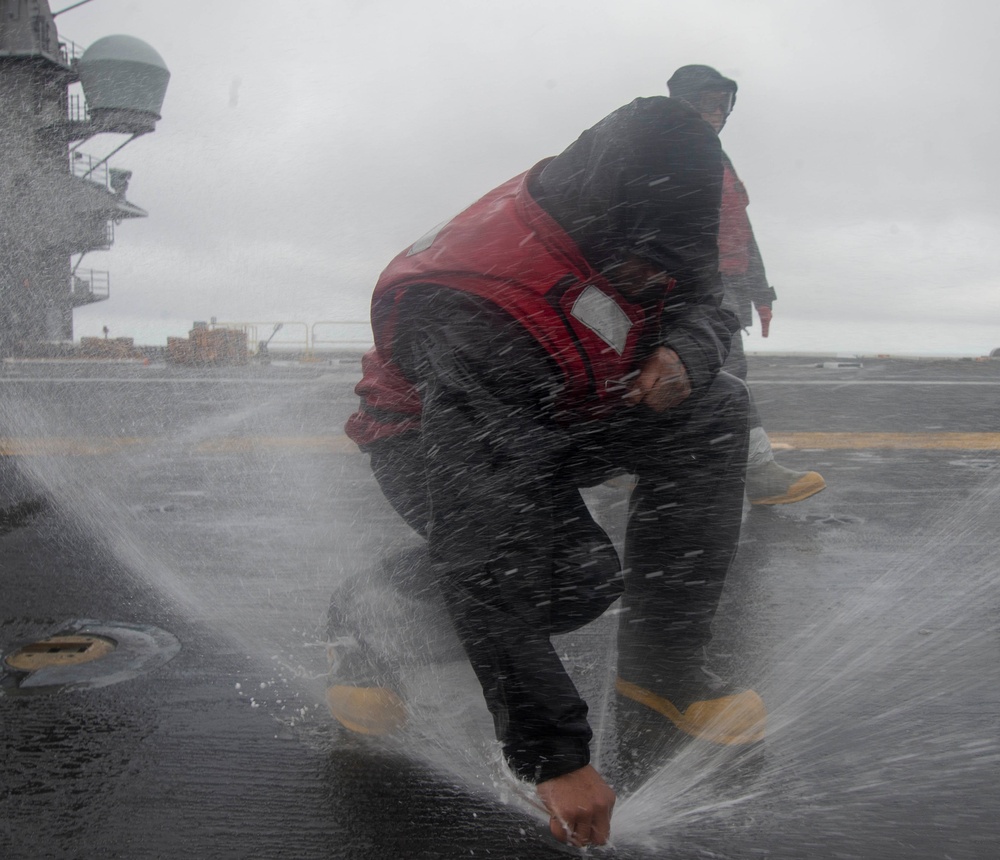 Sailor Clears Flight Deck Nozzle