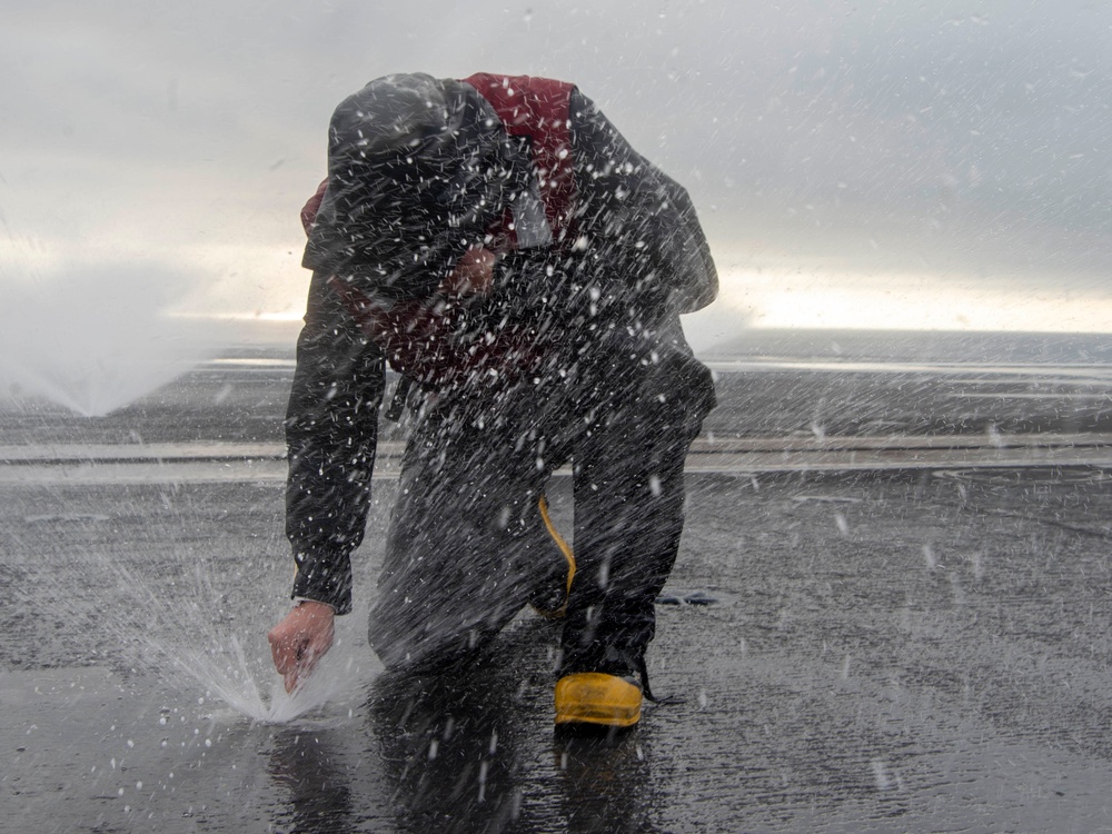 Sailor Clears Flight Deck Nozzle