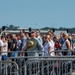 Audience Members Stand during National Anthem at Air Show