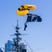 The U.S. Army Parachute Team jumps onto the USS Midway in San Diego